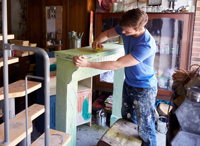 men roughing surface before painting melamine or laminate cabinet