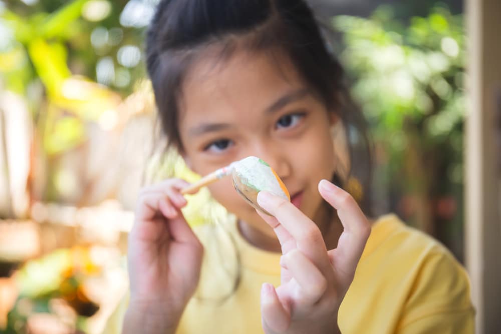 Little Girl doing Rock Paint