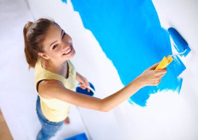 woman painting interior walls with Real Milk Paint blue