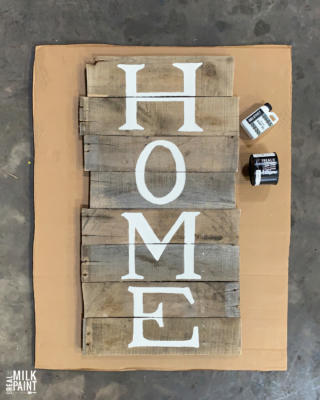 unfinished pallet sign that says home