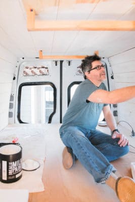 A man painting rv walls with Real Milk paint