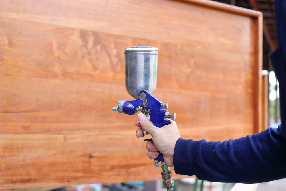 applying bleach to wood's entire surface easily with a spray bottle